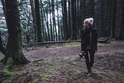 Mid adult woman walking in forest