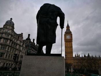 Low angle view of eiffel tower against cloudy sky