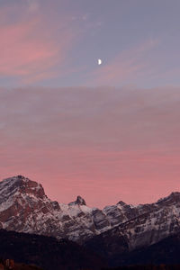 Scenic view of snowcapped mountains against sky during sunset