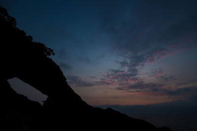 Low angle view of silhouette mountain against sky