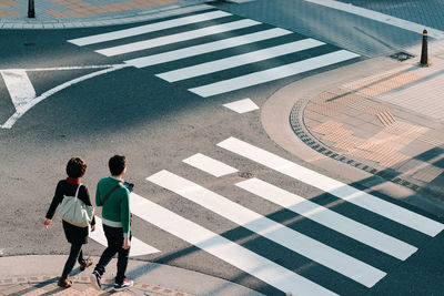 High angle view of people crossing road