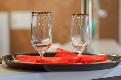 Close-up of wine glasses on table