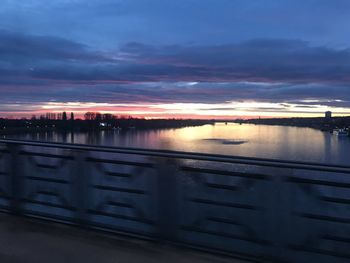 Scenic view of river against sky at sunset