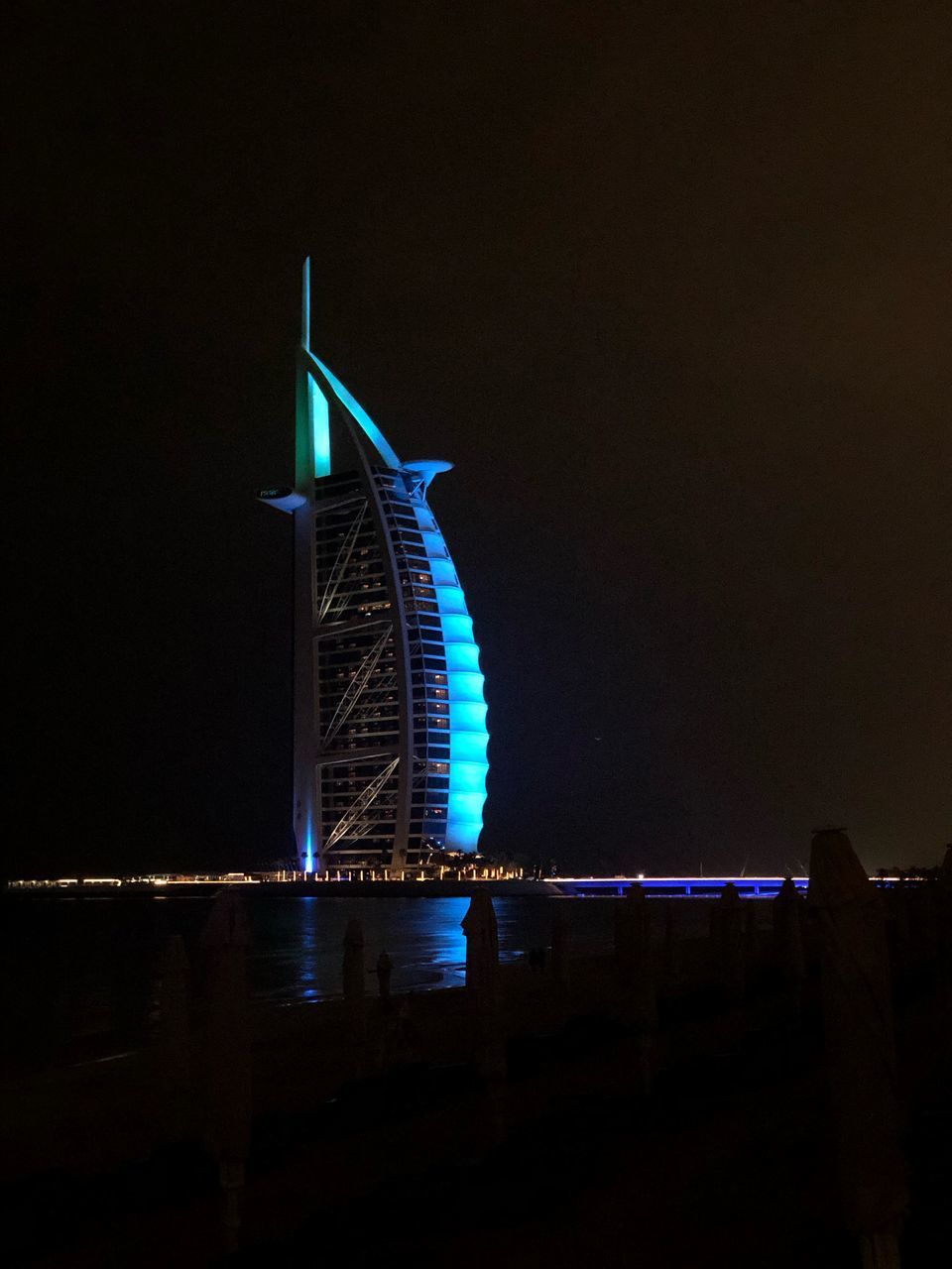 VIEW OF ILLUMINATED BRIDGE AT NIGHT