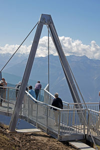 People at observation point against sky