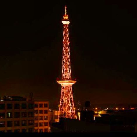 illuminated, night, famous place, built structure, international landmark, architecture, travel destinations, tourism, capital cities, tall - high, tower, city, sky, culture, outdoors, no people, city life, architectural feature, tall