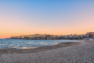 Scenic view of sea against clear sky during sunset