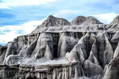 Scenic view of mountains against cloudy sky