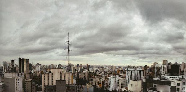 Cityscape against cloudy sky