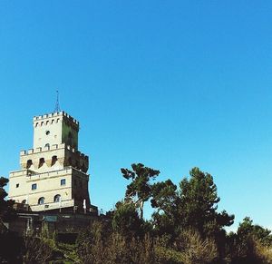 Low angle view of built structure against clear blue sky