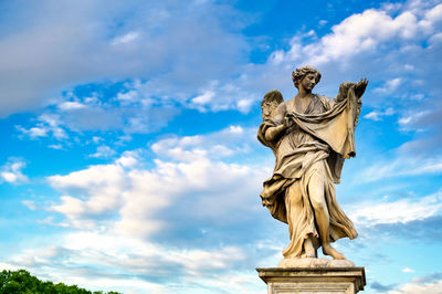 Low angle view of statue against cloudy sky