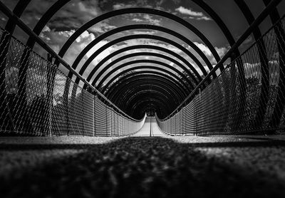 Close-up of metal bridge against sky