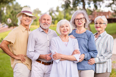 Portrait of smiling friends standing outdoors