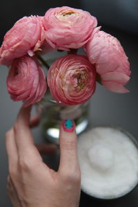 Cropped hand of woman holding rose