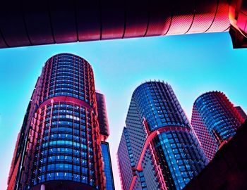 Low angle view of modern buildings against clear blue sky