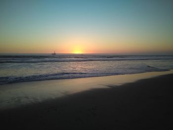 Scenic view of beach against sky during sunset