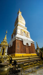 The pagoda of wat phra that panom temple in nakhon phanom in cloudy blue sky day with sunlight