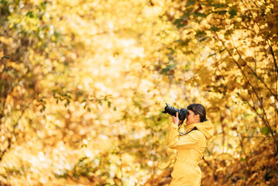 Rear view of woman standing on field