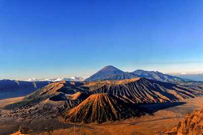 Scenic view of mountain range against blue sky