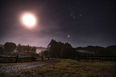 Scenic view of field against sky at night