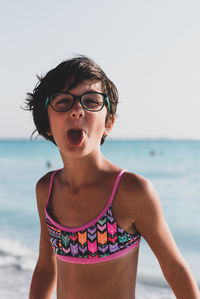 Portrait of girl making face at beach