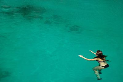 High angle view of woman swimming in sea