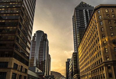 Low angle view of skyscrapers at sunset