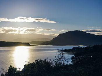 Scenic view of sea and mountains against sky