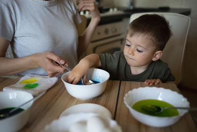 Portrait of boy eating food at home