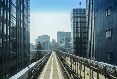 Empty narrow road along built structures