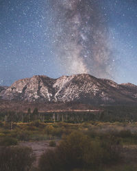 Scenic view of mountains against sky at night