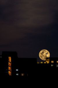 Low angle view of illuminated lights against sky at night