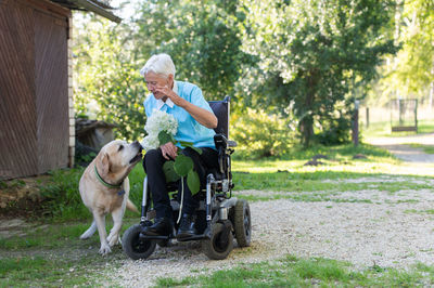 Side view of man with dog on field