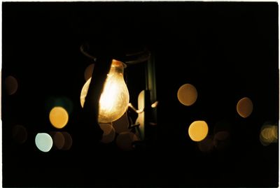 Close-up of illuminated light bulb in the dark