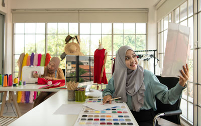 Muslim women run a small business in their own homes. is the design and tailoring of clothes.