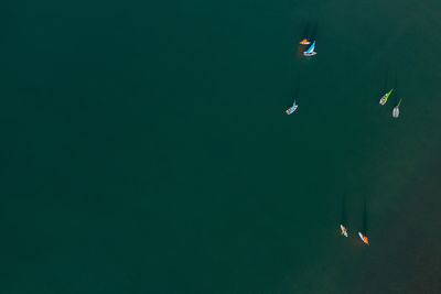 High angle view of kite floating on lake