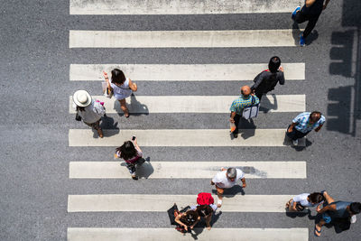 High angle view of people walking on road