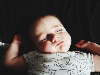 Close-up portrait of cute baby boy on bed