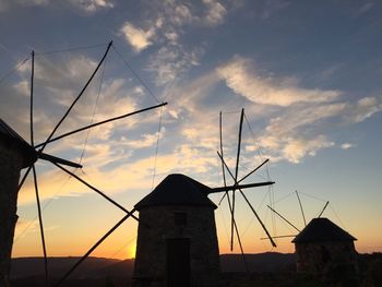 Low angle view of built structure against sky at sunset