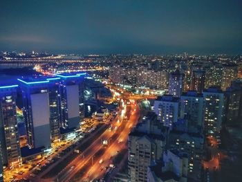 High angle view of illuminated cityscape against sky at night