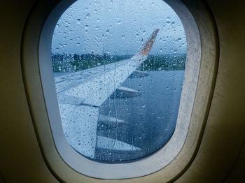 Close-up of wet airplane window