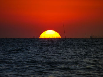 Scenic view of sea against orange sky