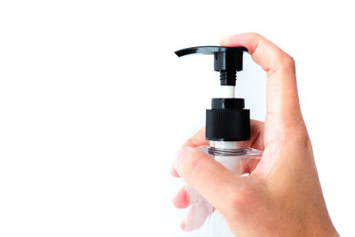 Close-up of hand holding hands over white background