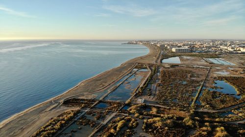 High angle view of sea and cityscape against sky