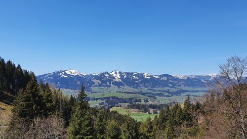 Scenic view of mountains against clear blue sky