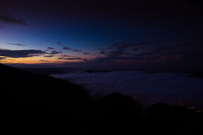 Scenic view of silhouette mountains against sky during sunset