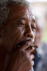 Close-up of man smoking outdoors