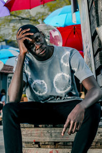 Portrait of young man sitting on seat