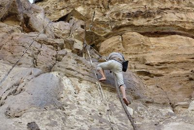 Low angle view of man climbing mountain