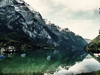 Scenic view of lake and mountains against sky